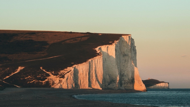 A tourist fell to her death while jumping for a photo at the edge of the famous Seven Sisters cliffs