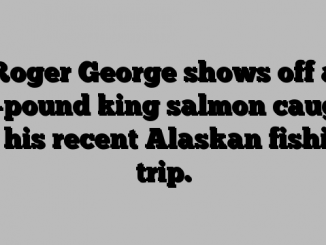 Roger George shows off a 20-pound king salmon caught on his recent Alaskan fishing trip.