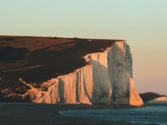 A tourist fell to her death while jumping for a photo at the edge of the famous Seven Sisters cliffs