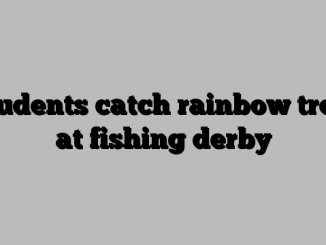 Students catch rainbow trout at fishing derby